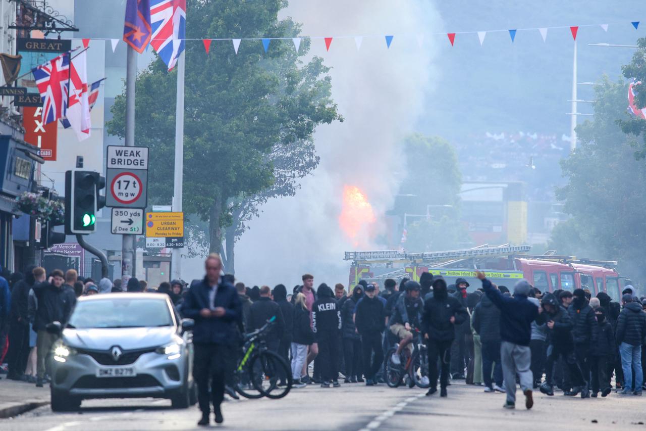 A burning bus is seen as protesters gather on the Newtownards road in east Belfast, Northern Ireland, in the evening of June 9, 2026. (AFP Photo)