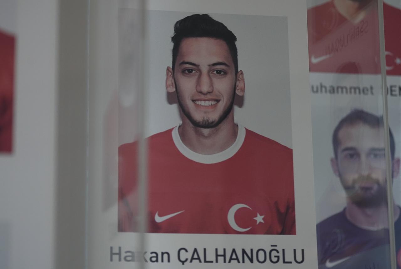 A display shows a young Hakan Calhanoglu in a Türkiye national team jersey as part of a feature on his football career. (AA Photo)