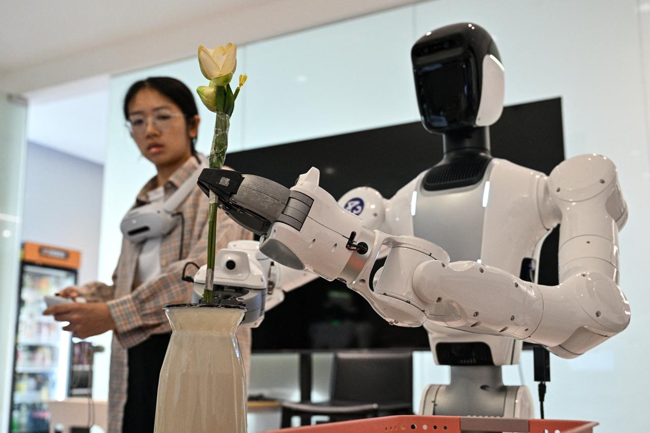 Engineer trains humanoid robot to do household tasks at the X Square Robot facilities in Shenzhen, southern China's Guangdong province, May 22, 2026. (AFP Photo)
