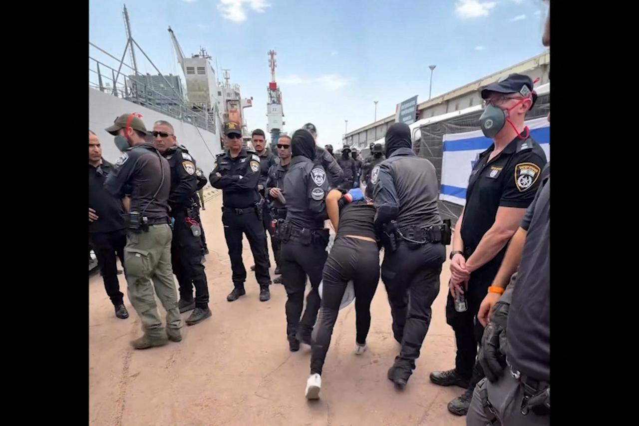 This screen grab on May 20, 2026, shows a detained activist from the Gaza-bound aid flotilla being escorted by security forces with their hands tied behind their backs. (Photo by X account of Israel's National Security Minister Itamar Ben Gvir/AFP)