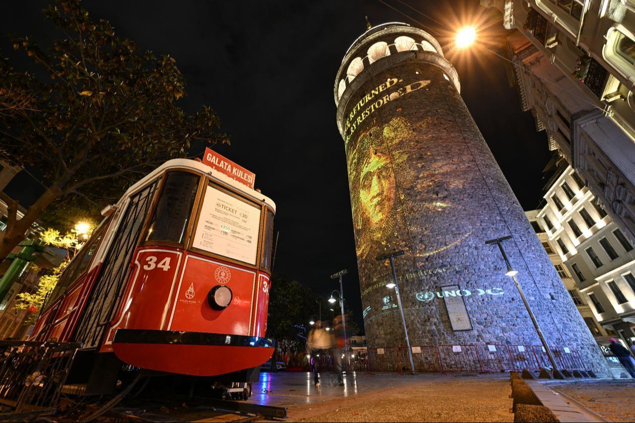 A projection mapping display highlighting cultural heritage protection is reflected on Galata Tower in Istanbul during an awareness campaign organized in cooperation with the Turkish Culture and Tourism Ministry and UNODC, May 13, 2026. (AA Photo)