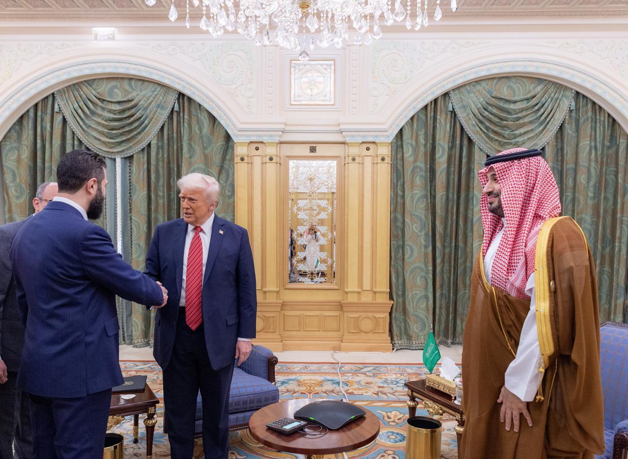 US President Donald Trump (C) meets with Syrian President Ahmad al-Sharaa (L) along with the Saudi Crown Prince Mohammed bin Salman Al Saud (R) in Riyadh, Saudi Arabia, May 14, 2025. (Photo via Bandar Al-Jaloud/Saudi Royal Court/Handout)