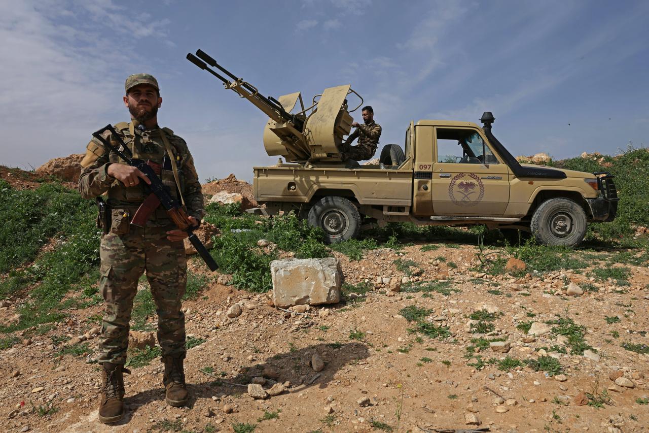 A Syrian army soldier stands guard next to an armored vehicle positioned along the Syrian–Lebanese border in the rural area of Al Qusayr on April 1, 2026. (AFP Photo)