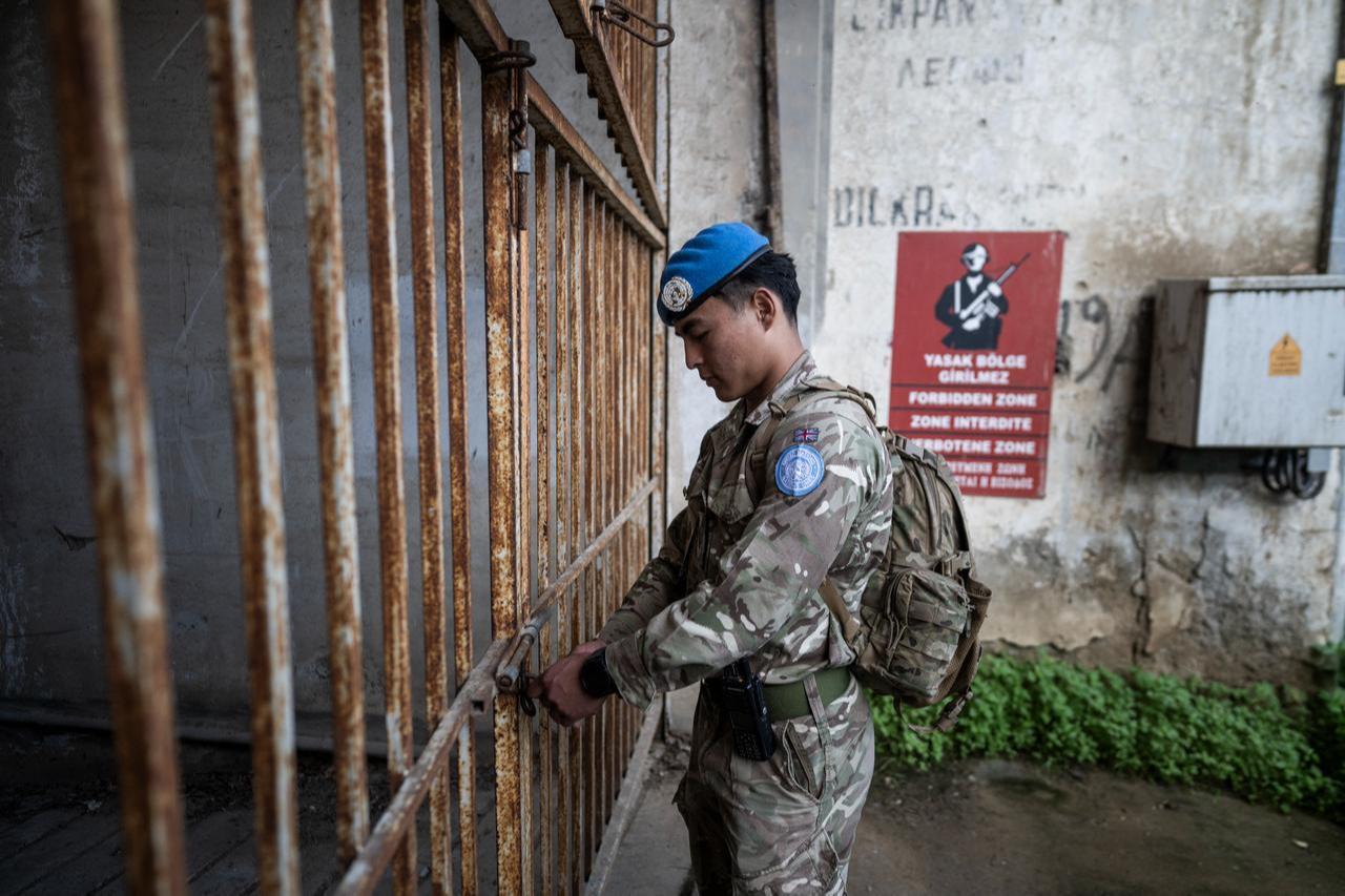 British troop opens the gate to an underground car park while patrolling the buffer zone separating the Greek Cyprus and Turkish Cyprus in Nicosia, Feb. 17, 2026. (AFP Photo)