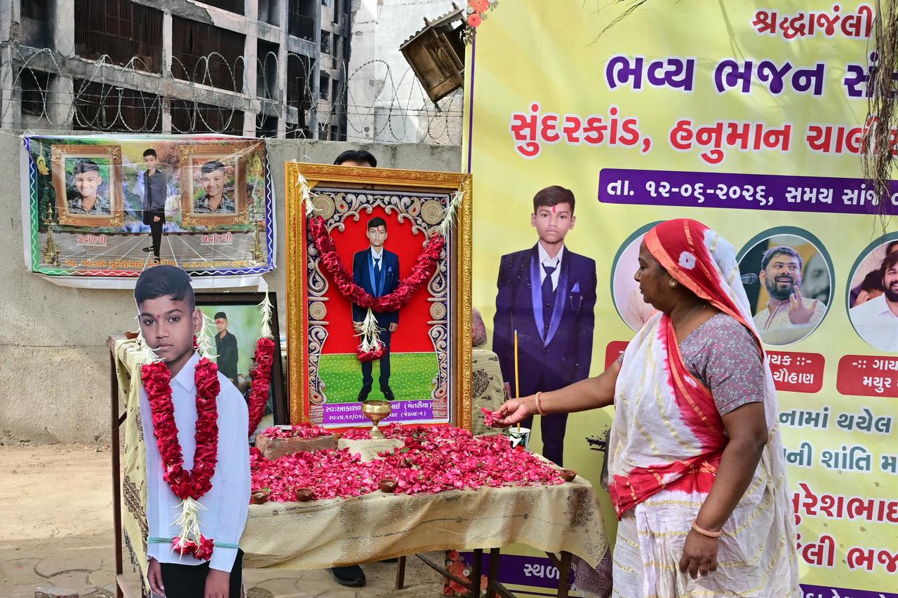 A family member of Air India Flight 171 plane crash victim Akash Patni pays tribute on the first anniversary of the disaster in Ahmedabad on June 12, 2026. (AFP Photo)