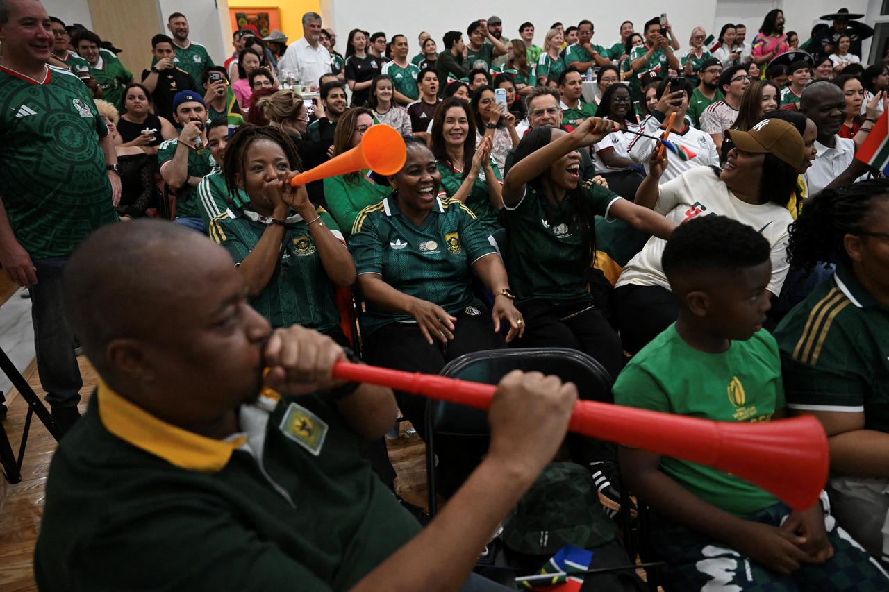 Mexican and South African fans react as they watch the live broadcast of the World Cup Group A football match between Mexico and South Africa at the Mexican embassy in Beijing on June 12, 2026. (AFP Photo)