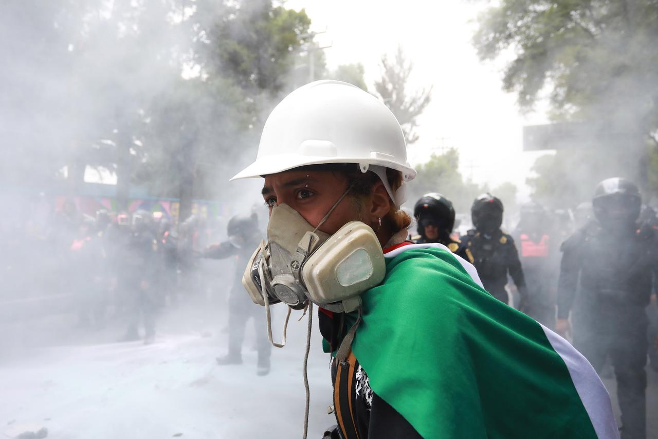 Demonstrators clash with riot police near Banorte Stadium during the World Cup opener, in Mexico City, June 11, 2026. (AA Photo)