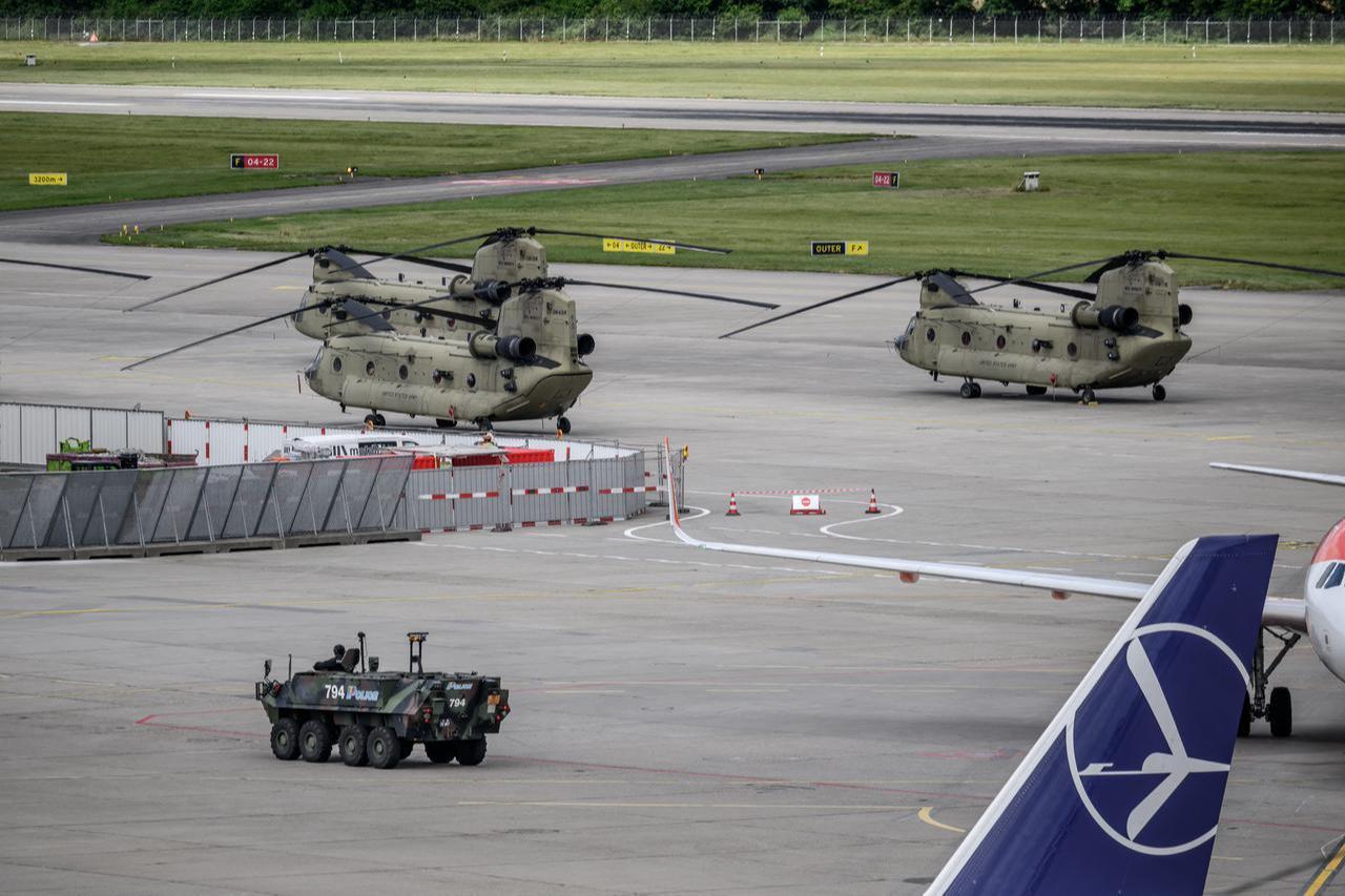 An armored vehicle of the Swiss police passes in front of a US Army CH-47F Chinook helicopter during a patrol on the tarmac at Geneva Airport in Geneva, June 11, 2026. (AFP Photo)