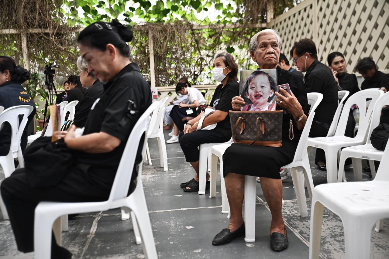 Mourners hold photos of Thai Princess Bajrakitiyabha Mahidol inside Chulalongkorn Hospital in Bangkok on June 12, 2026. (AFP Photo)