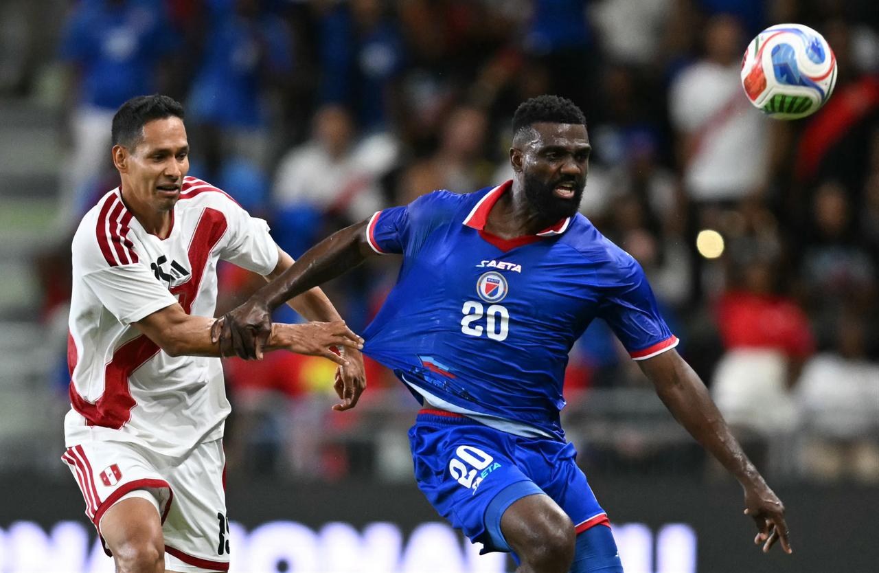 Haiti's forward #20 Frantzdy Pierrot and Peru's defender #15 Renzo Garces vie for the ball during the international friendly football match between Haiti and Peru at Nu Stadium in Miami, Florida, June 5, 2026. (AFP Photo)