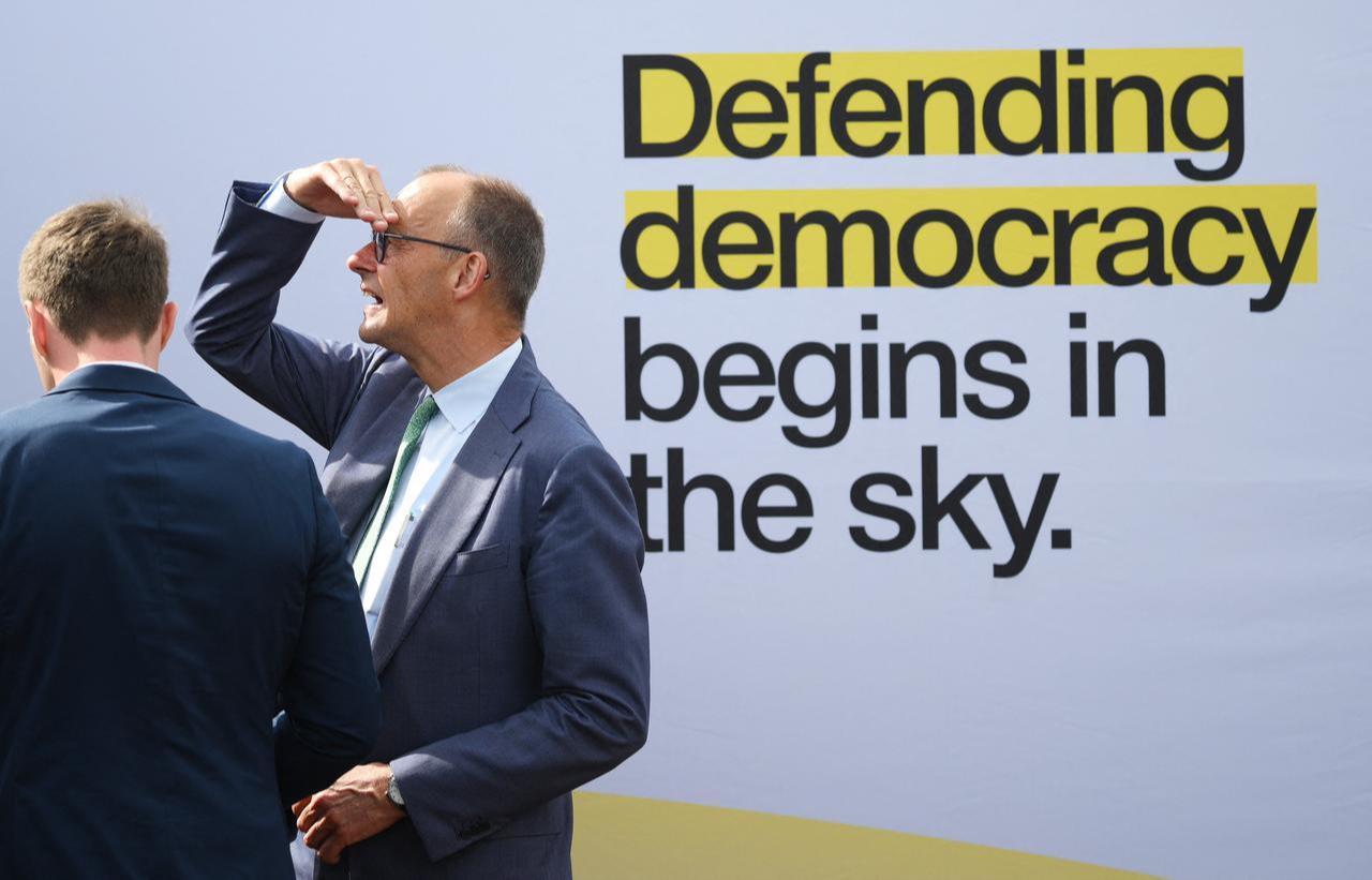 German Chancellor Friedrich Merz (R) looks up during the opening day of the International Aerospace Exhibition (ILA) in Schoenefeld, near Berlin, June 10, 2026. (AFP Photo)