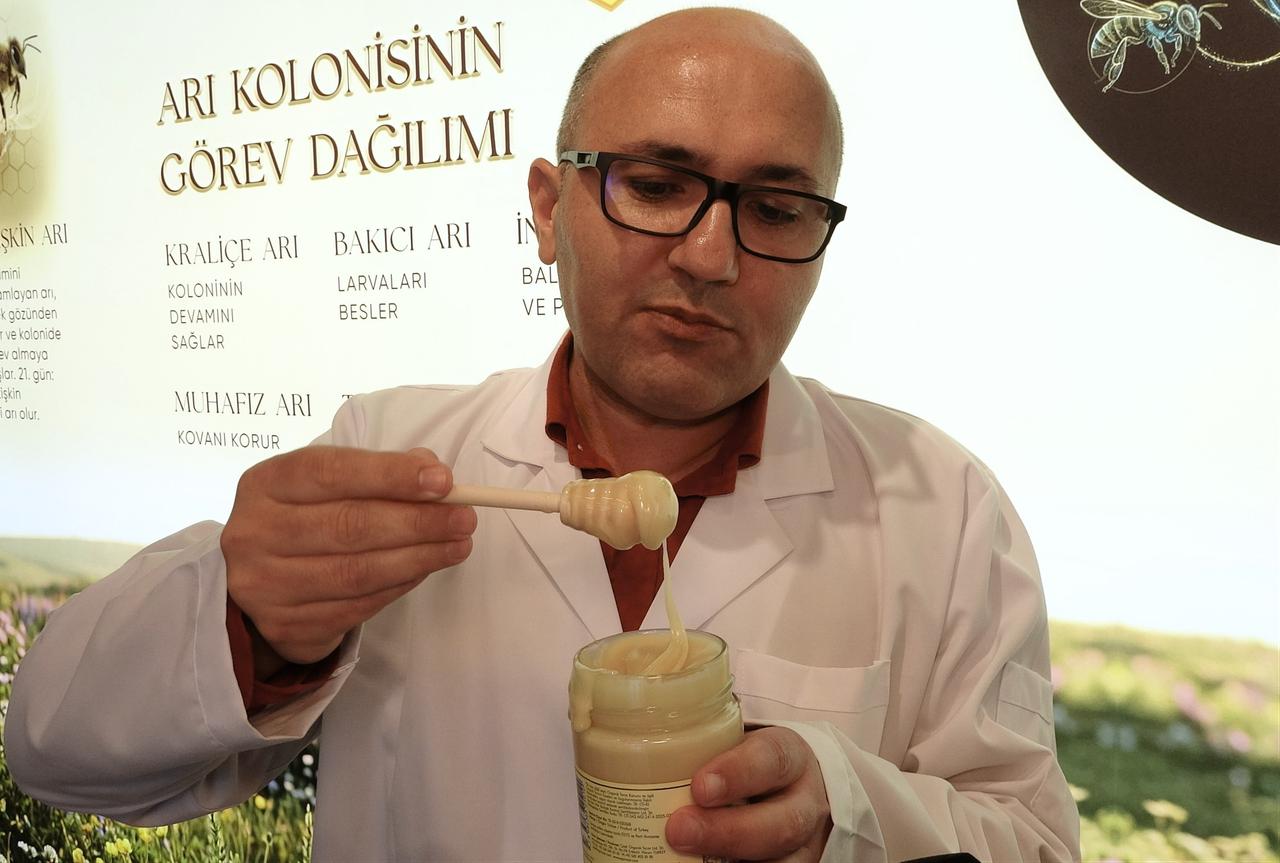 Beekeeper Celal Cay said the white honey is 100% natural flower honey formed through natural crystallization without additives. Mersin, Türkiye, June 13, 2026. (IHA Photo)
