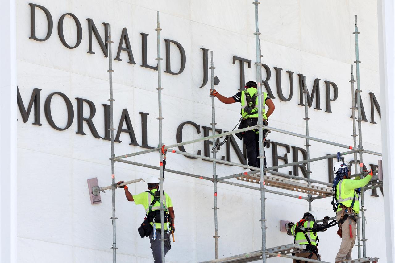 Workers stand on scaffolding near the signage for the Donald J. Trump and John F. Kennedy Memorial Center for the Performing Arts in Washington, DC, June 12, 2026. (AFP Photo)