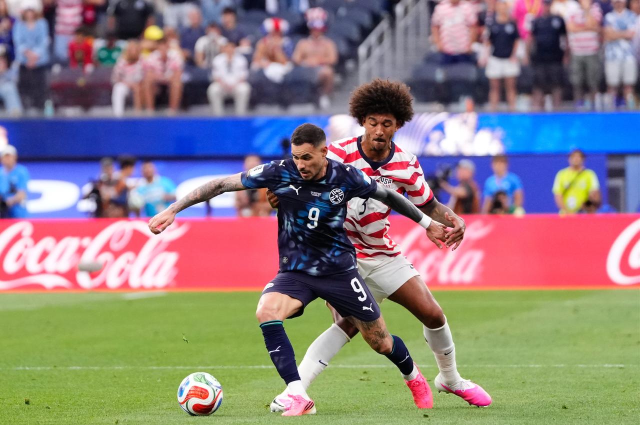 Chris Richards of USA and Antonio Sanabria of Paraguay compete for the ball during the 2026 FIFA World Cup First Stage Group D match between USA and Paraguay at SoFi Stadium (Los Angeles Stadium) in Los Angeles, California, United States, June 12, 2026. (AA Photo)