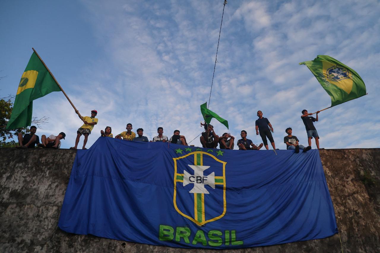Football fans wave Brazilian flags as they watch the FIFA World Cup 2026 match between Brazil and Morocco on giant screen during public viewing event at Fort Oranje in Ternate, North Maluku, on June 14, 2026. (AFP Photo)