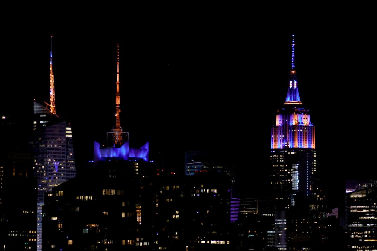 The Empire State Building is lit with the colors of New York Knicks after the New York Knicks defeated the San Antonio Spurs in Game 5 of the NBA Finals to win the series, as seen from West New York, New Jersey, on June 13, 2026. (AFP Photo)