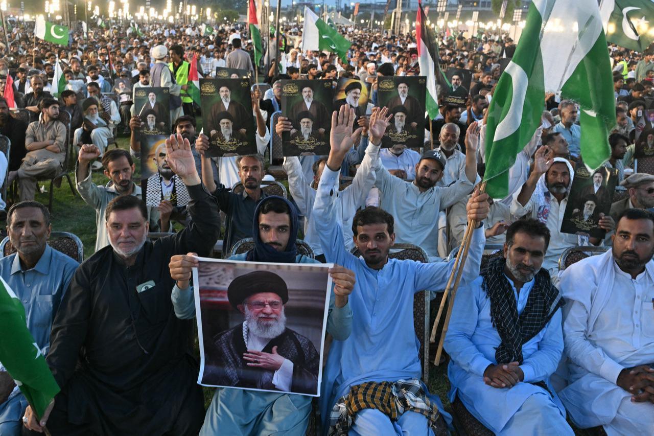 Activists carry portraits of Iran’s slain supreme leader Ali Khamenei, as they pay tribute at Minar-e-Pakistan in Lahore on June 13, 2026. (AFP Photo)