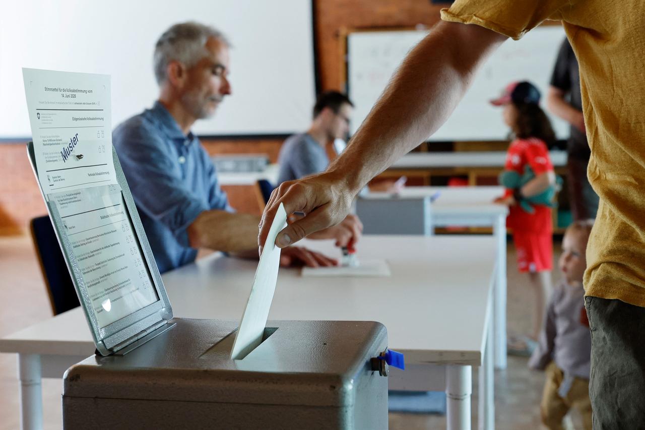 A citizen casts his ballot at a polling station in Bern, on June 14, 2026. (AFP Photo)