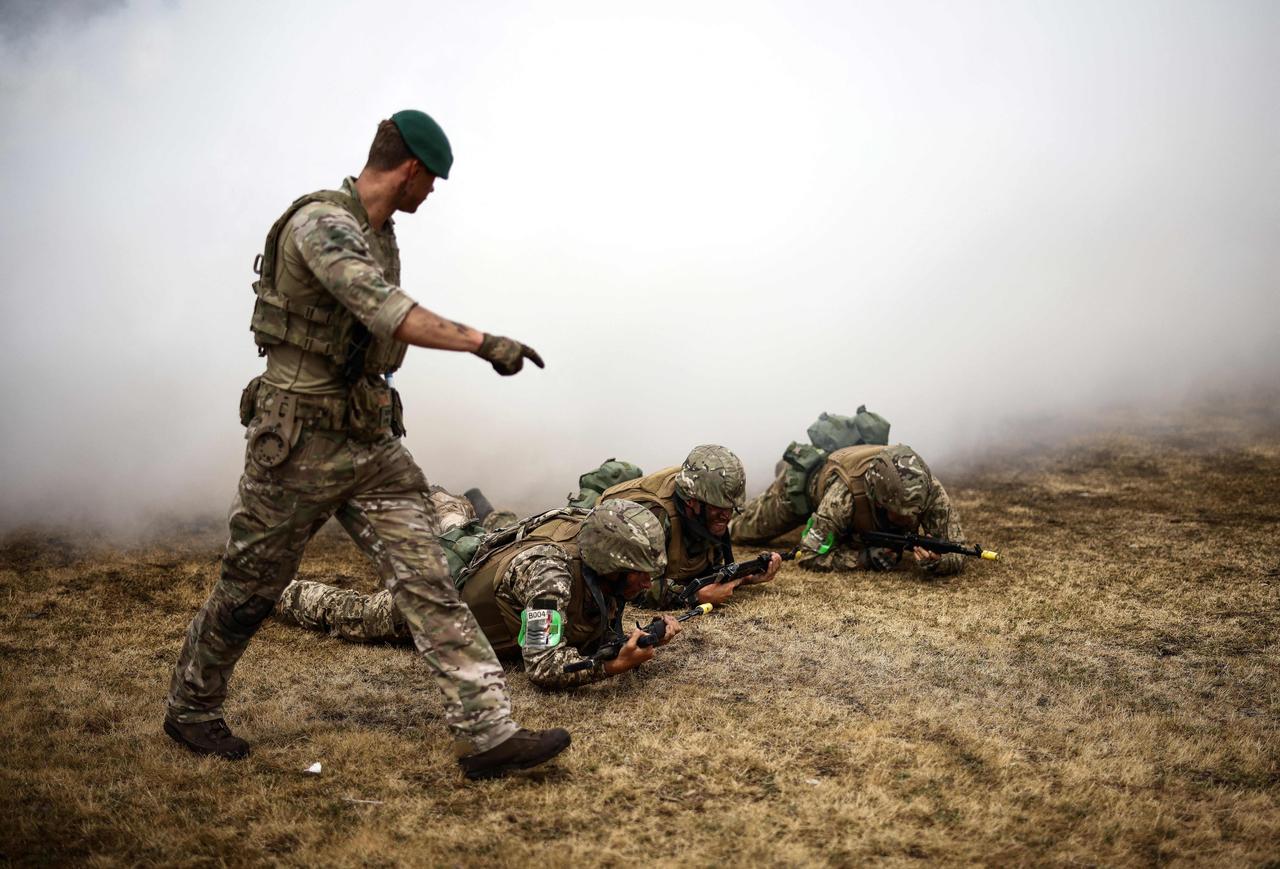 Ukraine Army recruits take part in a training session with members of Britain's Royal Marines from the 45 Commando (L), at a training base in southern England, June 20, 2023. (AFP Photo)