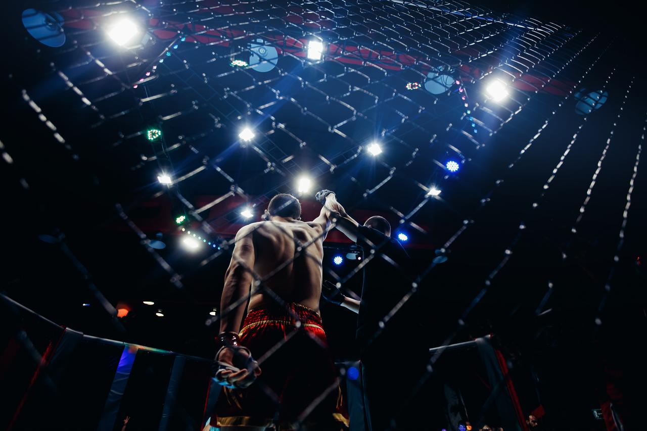 Man winning UFC battle. (Photo via Adobe Stock)