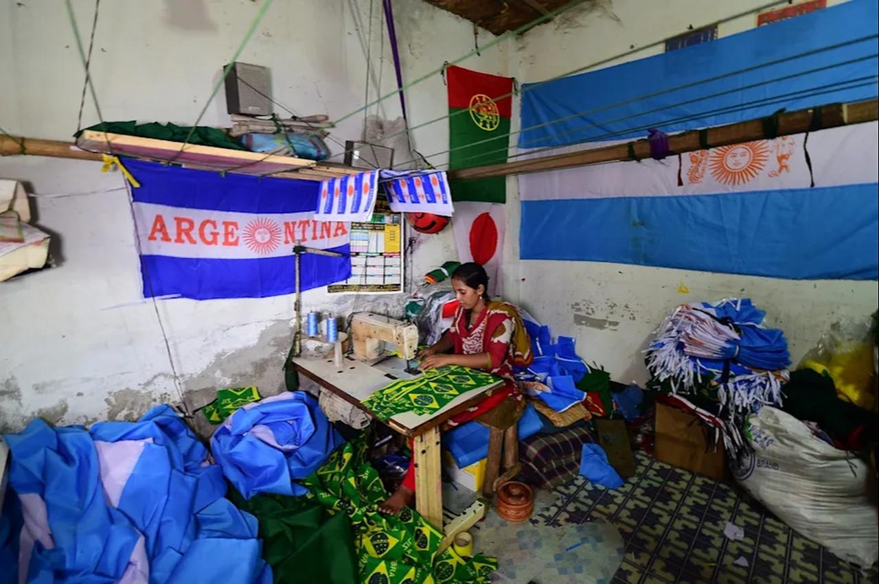 A Bangladeshi worker sewing flags for the World Cup football playing nations in Narayanganj, on the outskirts of Dhaka, ahead of the 2018 football World Cup (AFP Photo)