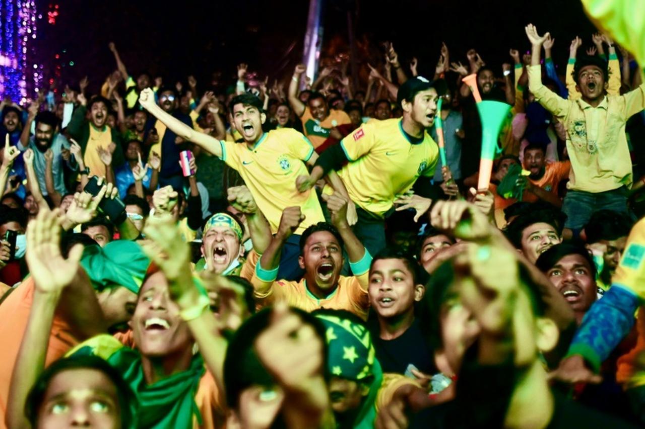 Football fans celebrate as Brazil scores against South Korea while watching their World Cup match on December 6, 2022. (AFP Photo)