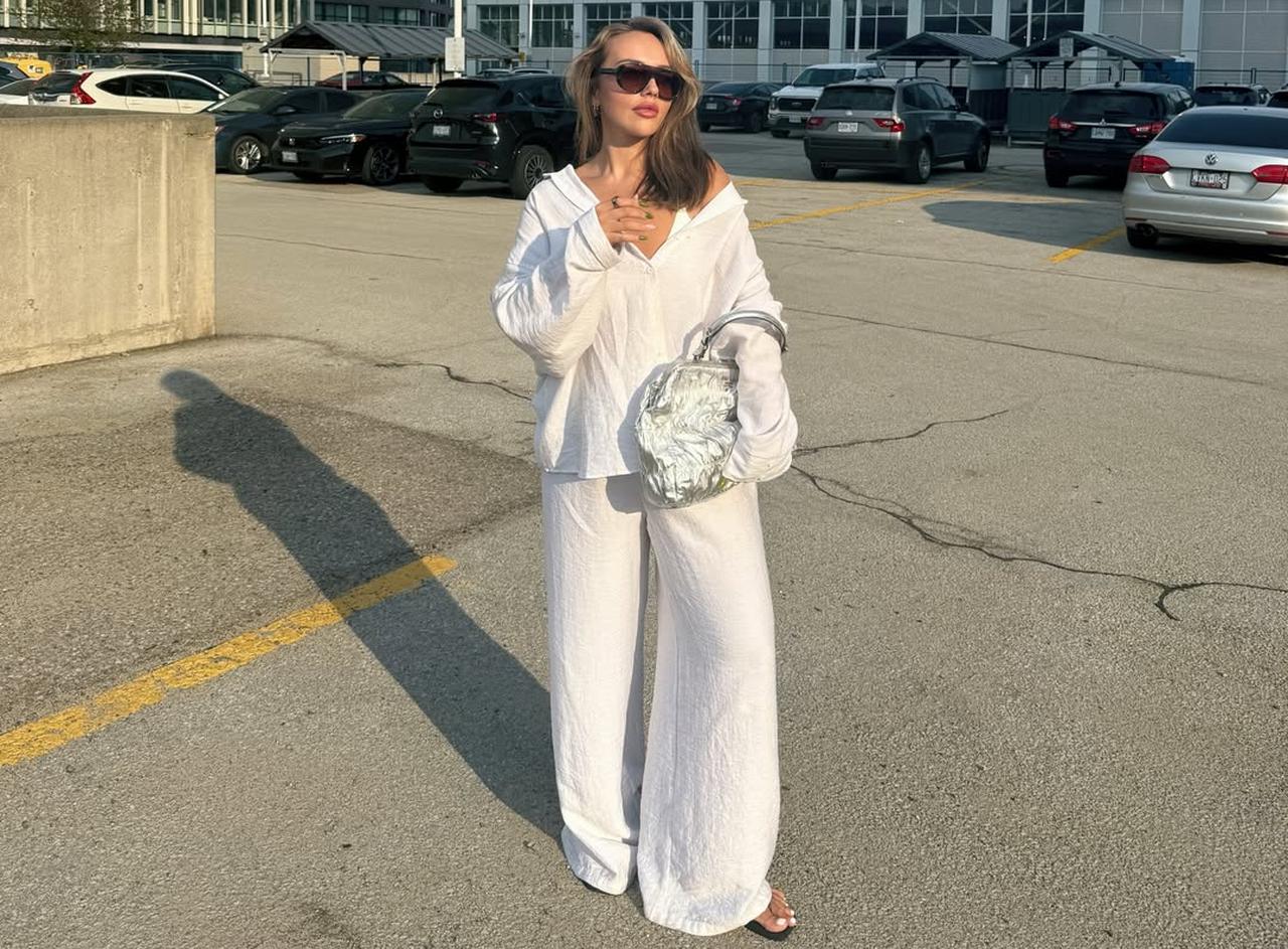 A social media influencer Natali Ambri poses in an all-white summer outfit in an urban parking area, May 18, 2026. (Photo via Instagram/@natali.ambri)