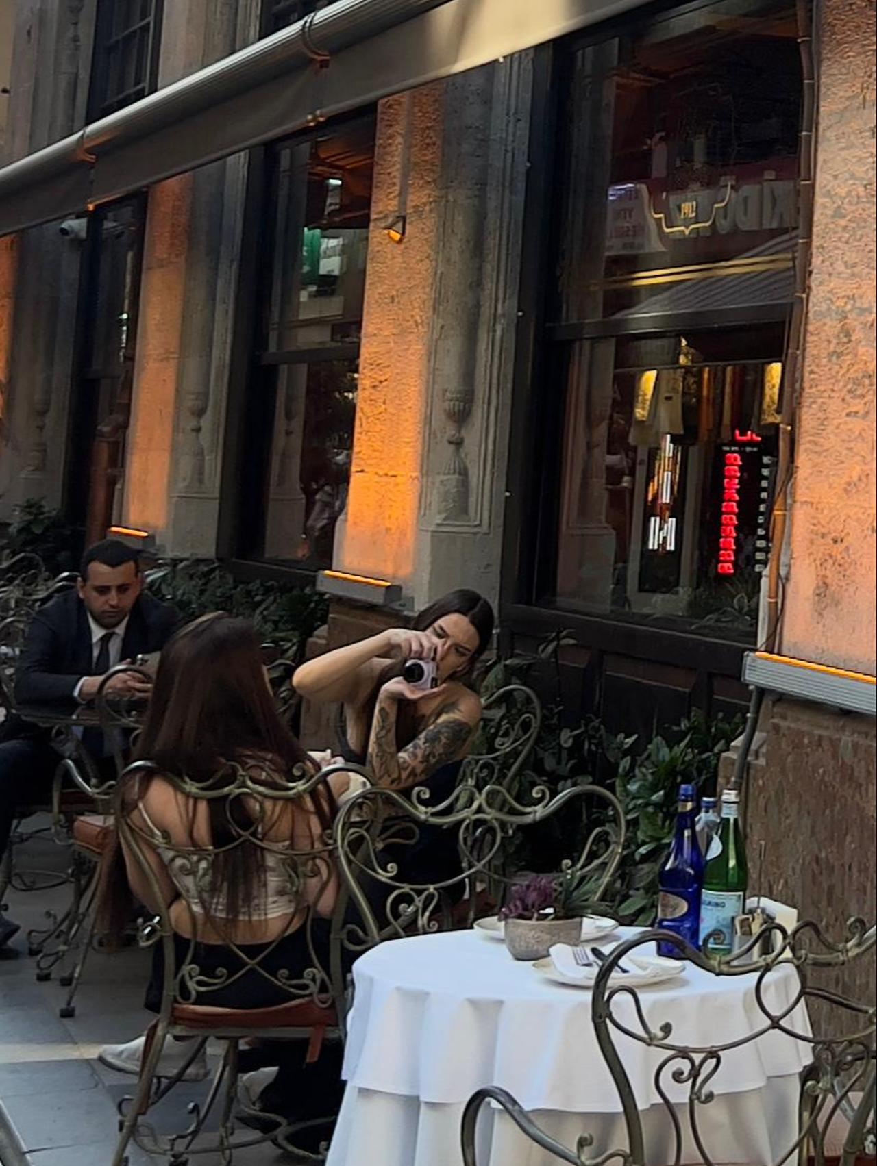 Two women photograph each other outside Sirkeci Lokantası 1912, reflecting how cafés and restaurants have become backdrops for social media content creation as much as places to dine. (Photo by Türkiye Today)