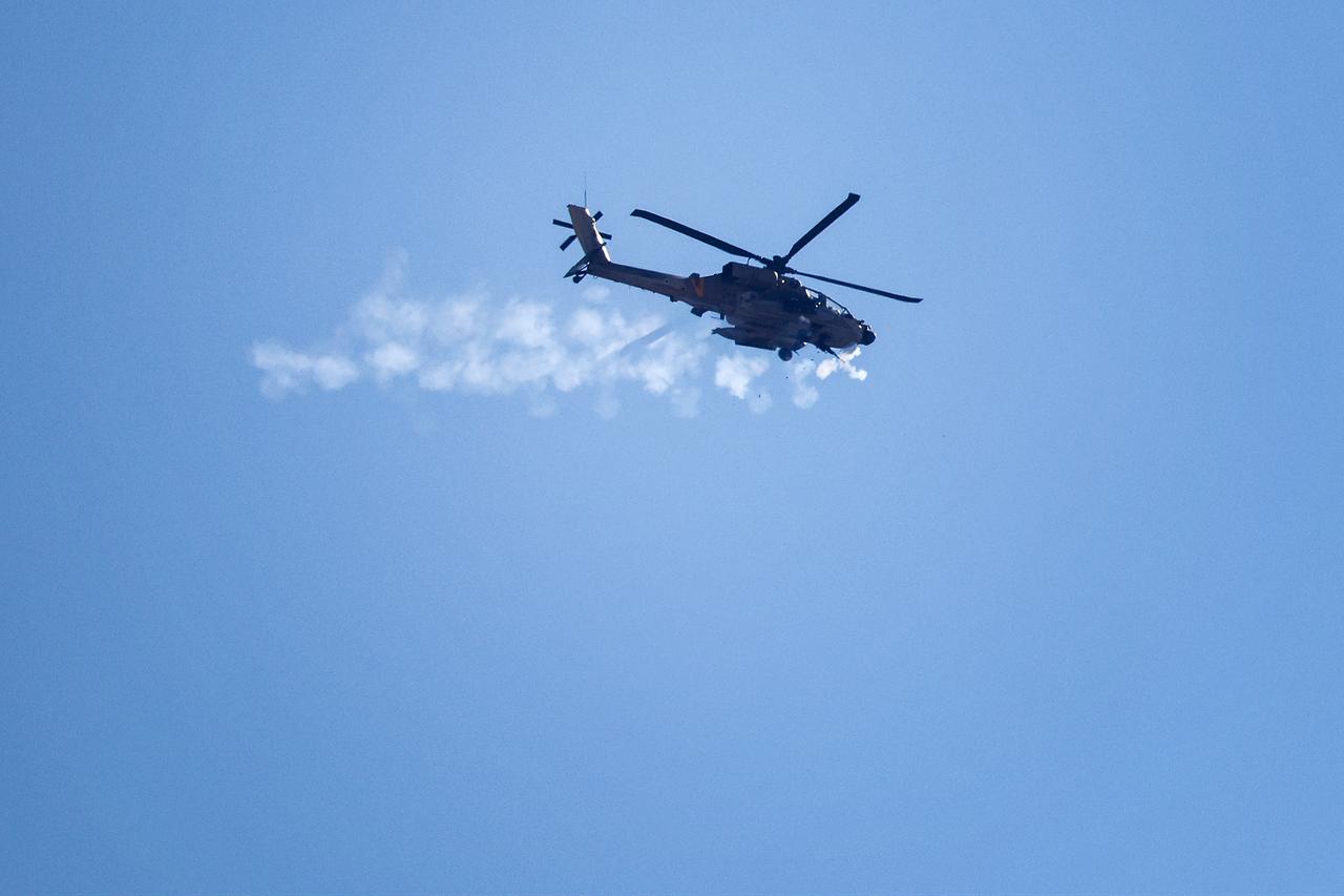 An Israeli AH-64 Apache Longbow helicopter fires its machine gun near Israel's northern border with the Gaza Strip on May 29, 2025. (AFP Photo)