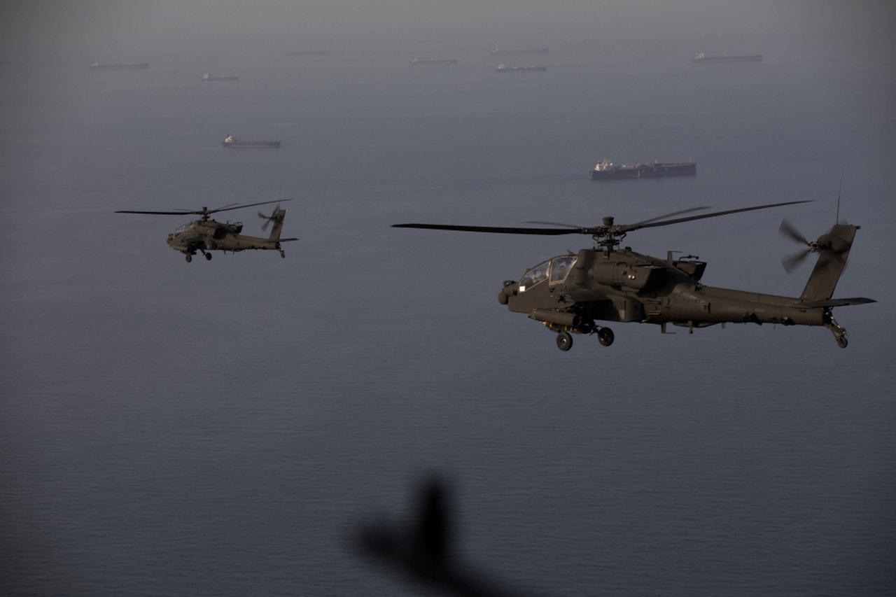 This handout photo, taken on April 18, 2026, shows AH-64 Apaches flying above the Strait of Hormuz during a patrol on April 17, 2026. (Photo by US Central Command (CENTCOM)/AFP)