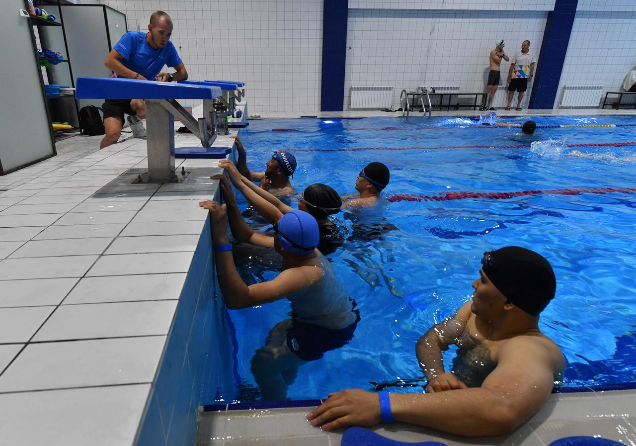 Aizaratbek Esenov (R) attends swimming training at the Triathlon Centre in Bishkek on April 29, 2026. (AFP Photo)