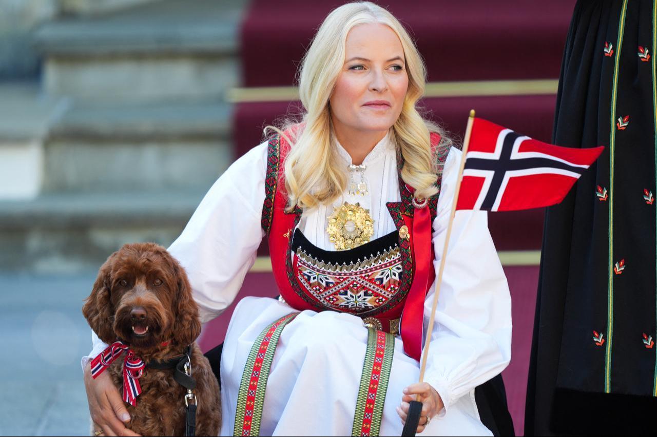 Norwegian Crown Princess Mette-Marit holds a Norwegian flag alongside the family dog during the May 17 National Day celebrations at the Royal residence Skaugum, in Oslo, Norway, May 17, 2024. (AFP Photo)