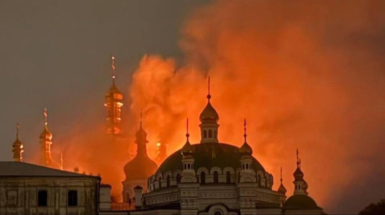 Smoke and flames rise behind the domes of Kyiv Pechersk Lavra after a major Russian attack on the Ukrainian capital, June 15, 2026. (Photo via X/@AmbVasyl)