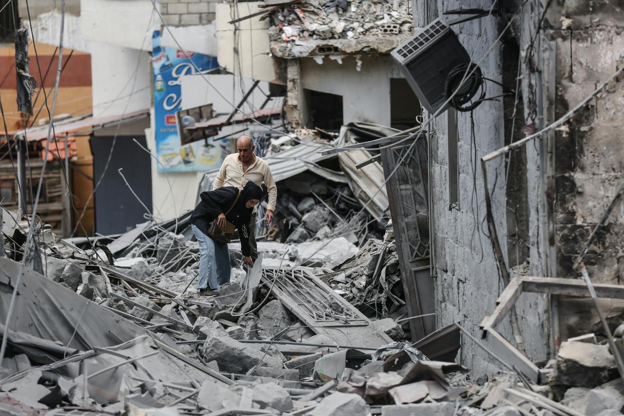 People make their way through the rubble of a destroyed building as residents displaced by fighting return to Nabatieh in southern Lebanon, June 15, 2026. (AFP Photo)