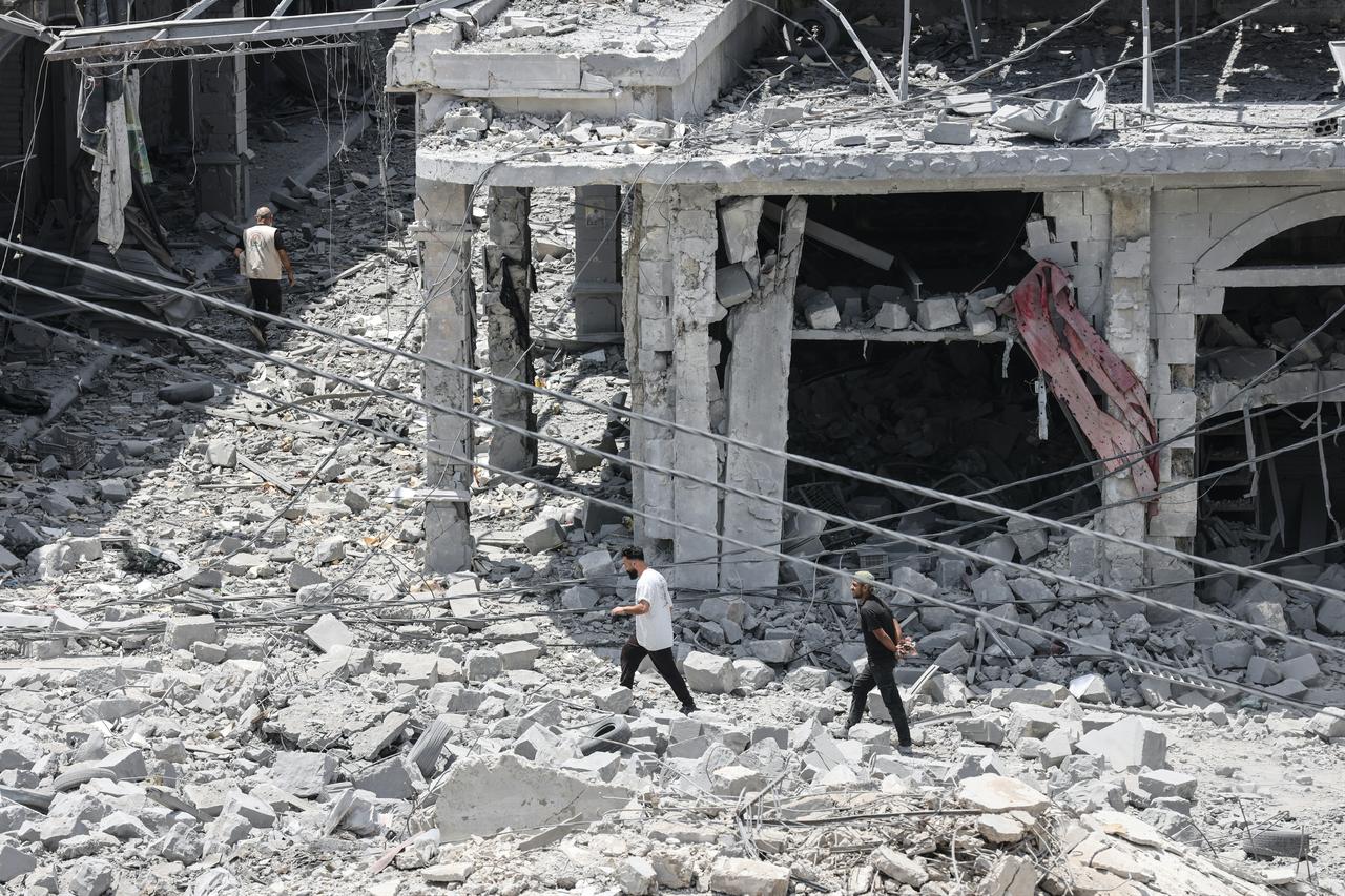 People make their way through the rubble of a destroyed building as residents displaced by fighting return to Nabatieh in southern Lebanon, June 15, 2026. (AFP Photo)