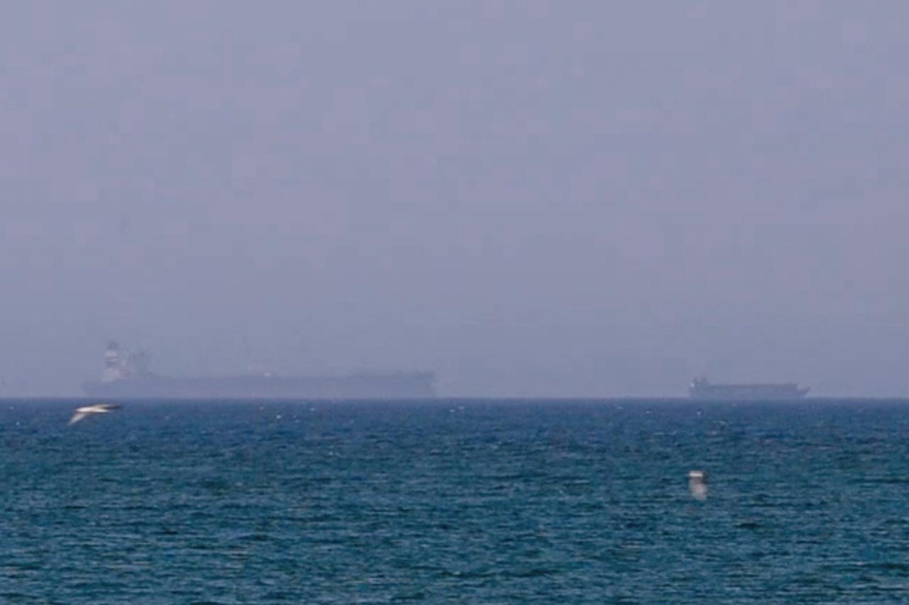 A screen grab taken from a video shows commercial vessels waiting in the Gulf of Oman after applying for transit permits to pass through the Strait of Hormuz, on June 4, 2026. (AA Photo)