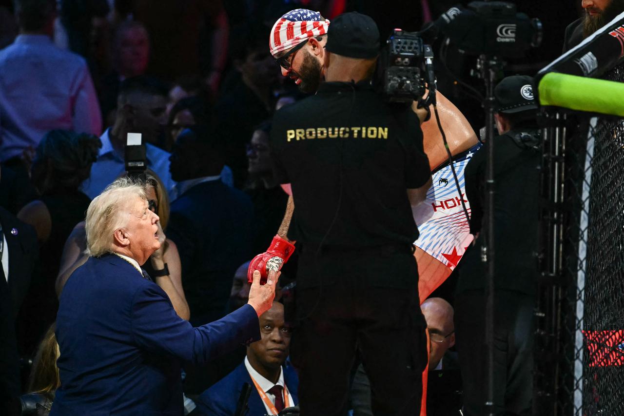 US President Donald Trump shakes hands with America's Josh Hokit during the "UFC Freedom 250" mixed martial arts event on the South Lawn of the White House in Washington, DC, June 14, 2026. (AFP Photo)