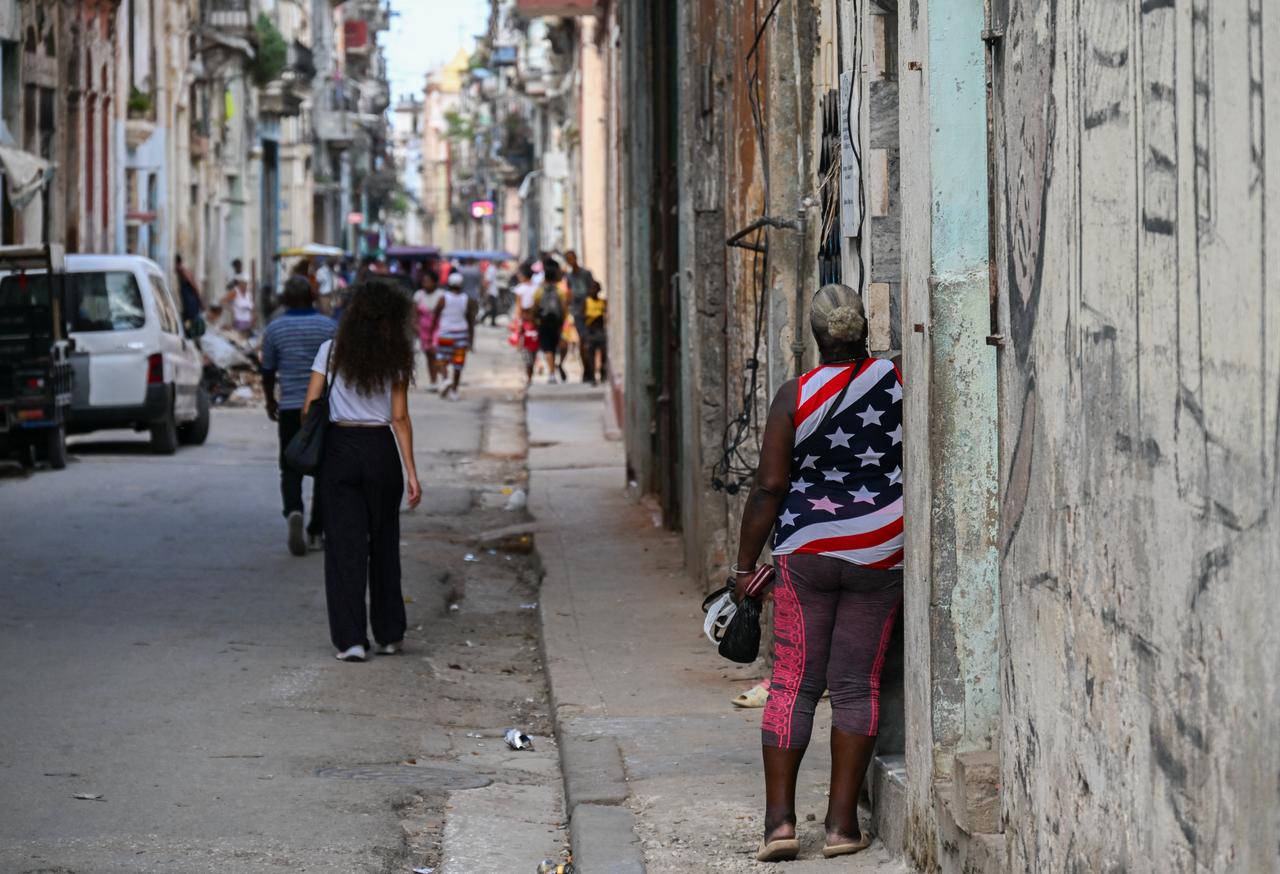 A woman wearing a T-shirt featuring the US flag walks along a street in Havana on June 15, 2026. (AFP Photo)