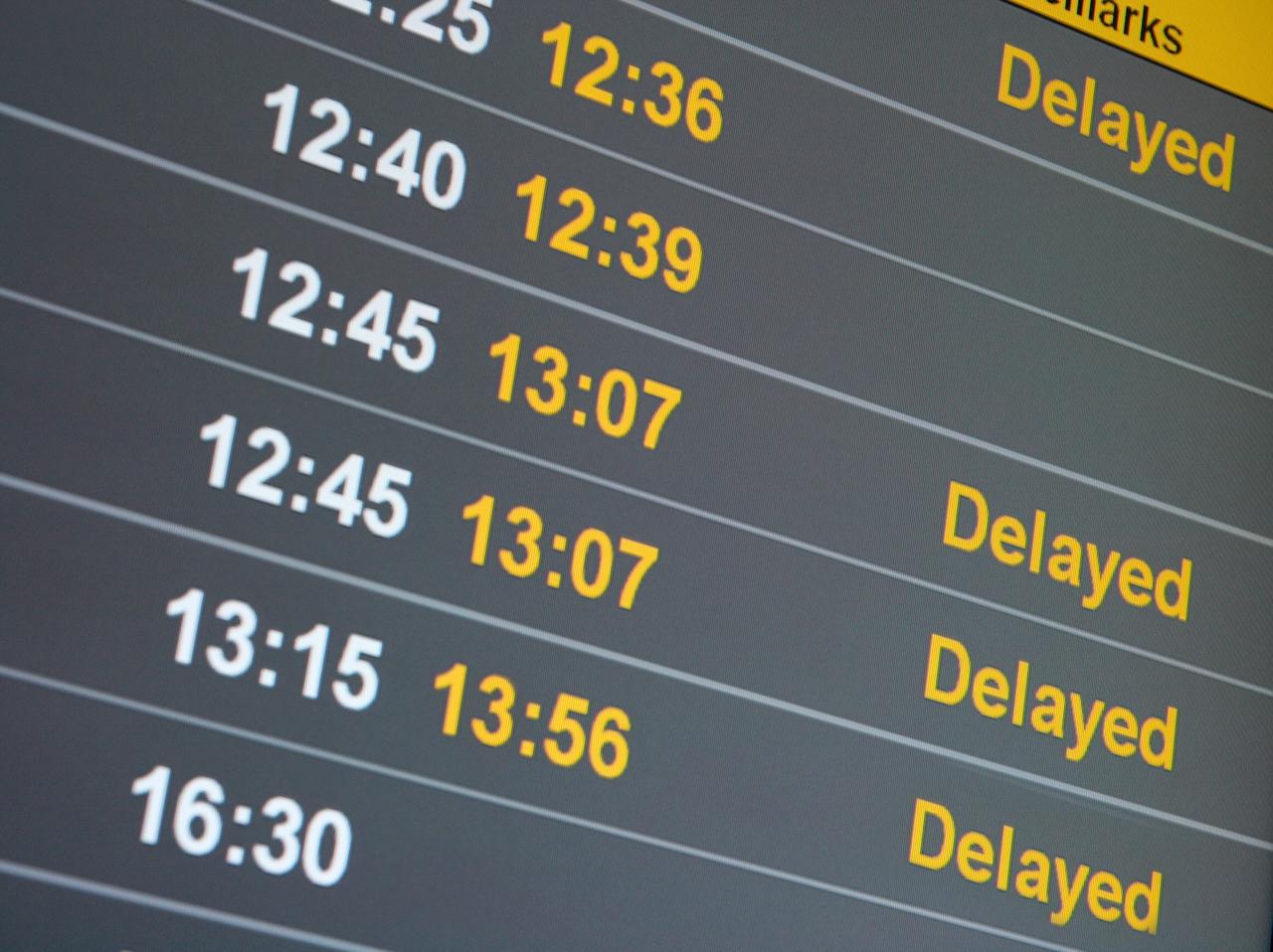 A flight information board displays multiple delayed departures at an airport. (Adobe Stock Photo)