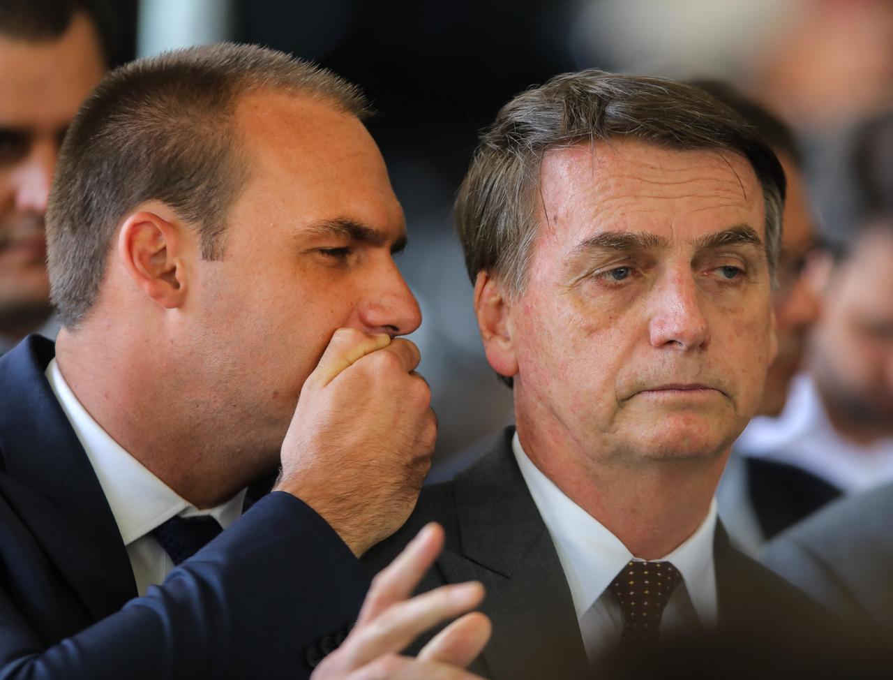 Jair Bolsonaro (R) listens to his son Eduardo Bolsonaro (L), on November 14, 2018. (AFP Photo)