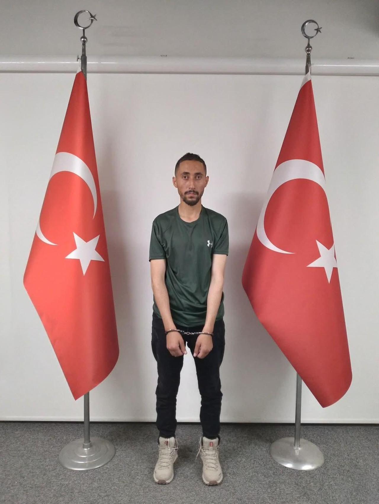 Ahmet Kazanci, a senior Daesh Khorasan operative captured by Türkiye's National Intelligence Organization (MIT), stands in handcuffs in Ankara, Türkiye, on June 17, 2026. (IHA Photo)