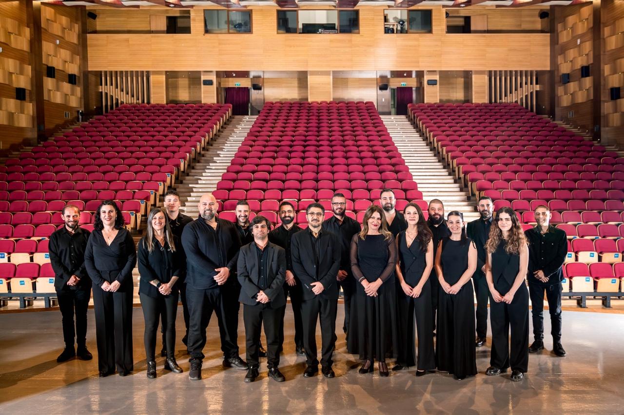 Members of the Famagusta City Orchestra pose on stage ahead of their festival performance with Fikri Karayel. (Photo via Famagusta Municipality)