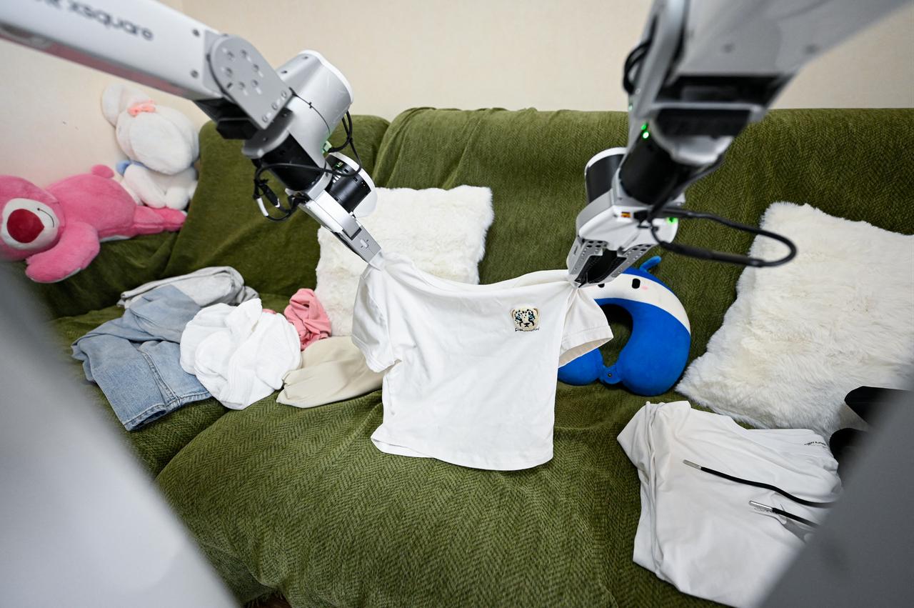 This picture shows an X Square Robot folding clothes at a customer's home in Beijing, China on May 21, 2026. (AFP Photo)
