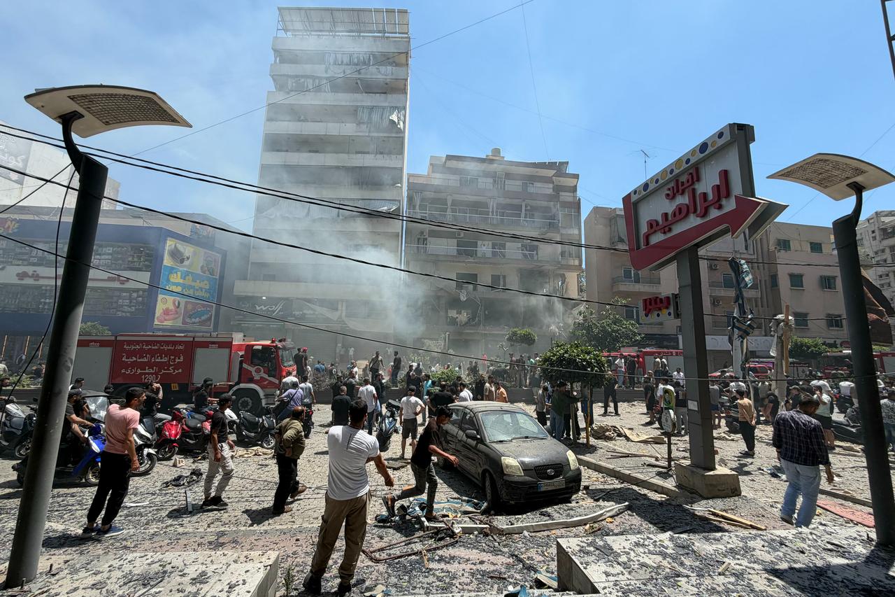 People gather at the site of an Israeli airstrike that targeted a building in Beirut’s southern suburbs on June 14, 2026. (AFP Photo)