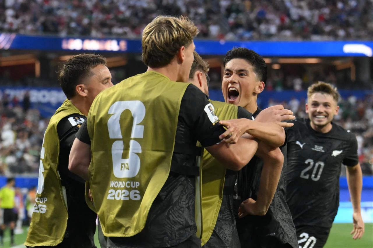 New Zealand's forward #11 Elijah Just celebrates with teammates after scoring his team's second goal during the 2026 World Cup Group G football match between Iran and New Zealand at Los Angeles Stadium in Inglewood, Los Angeles on June 15, 2026.  (AFP Photo)