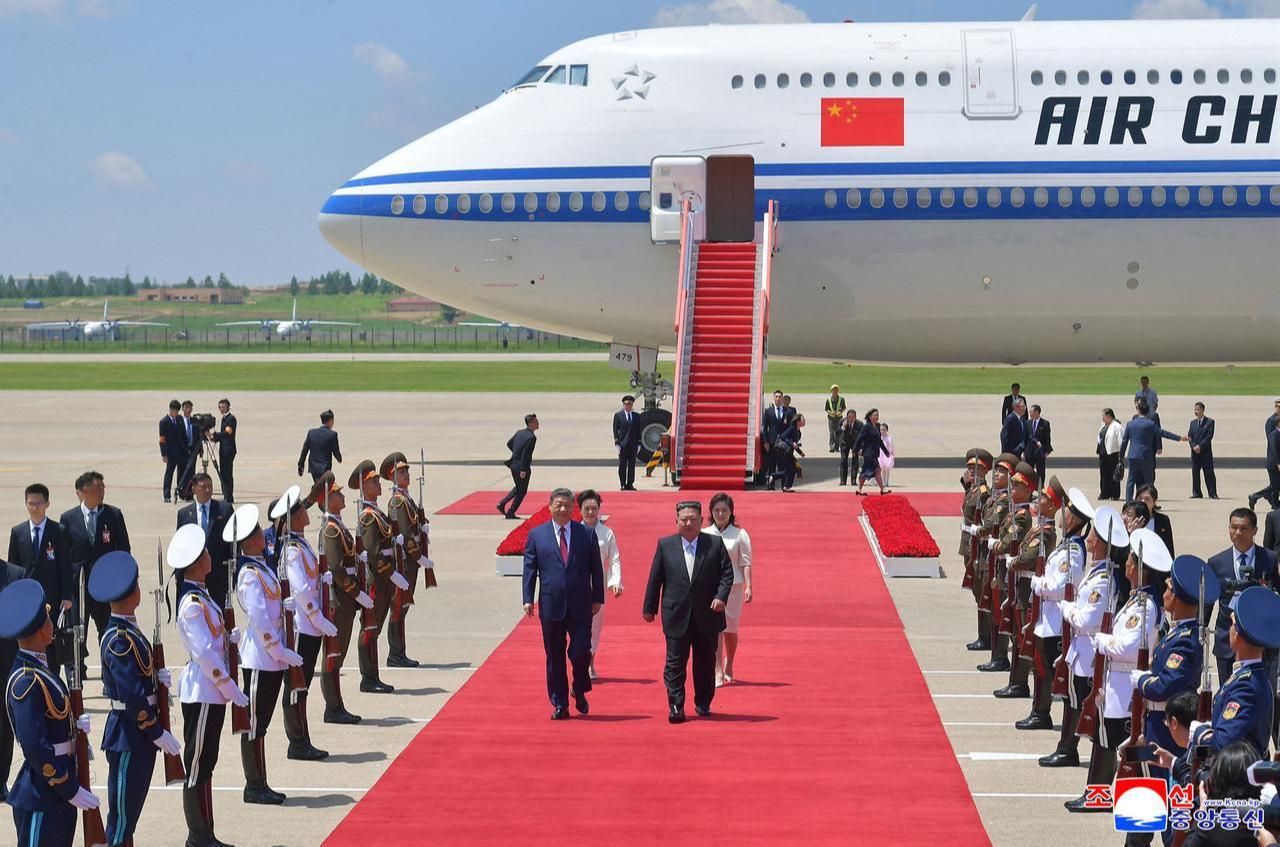 North Korean leader Kim Jong Un (center R) and his wife Ri Sol Ju (back R) welcoming China's President Xi Jinping (center L) and his wife Peng Liyuan (back L) upon their arrival at Pyongyang Airport, North Korea, June 8, 2026. (Photo by KCNA VIA KNS/AFP)