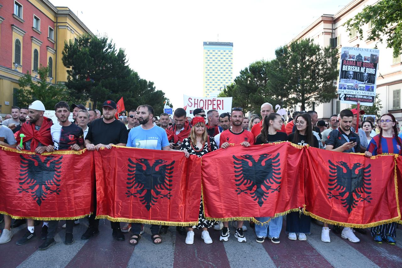 Protesters carrying Albanian flags march towards the Prime Ministry building along the Nation's Martyrs Boulevard (Bulevardi Deshmoret e Kombit) during a demonstration against a luxury tourism project in Zvernec linked to Ivanka Trump and Jared Kushner, on the 15th day of protests in Tirana, Albania on June 14, 2026. (AA Photo)