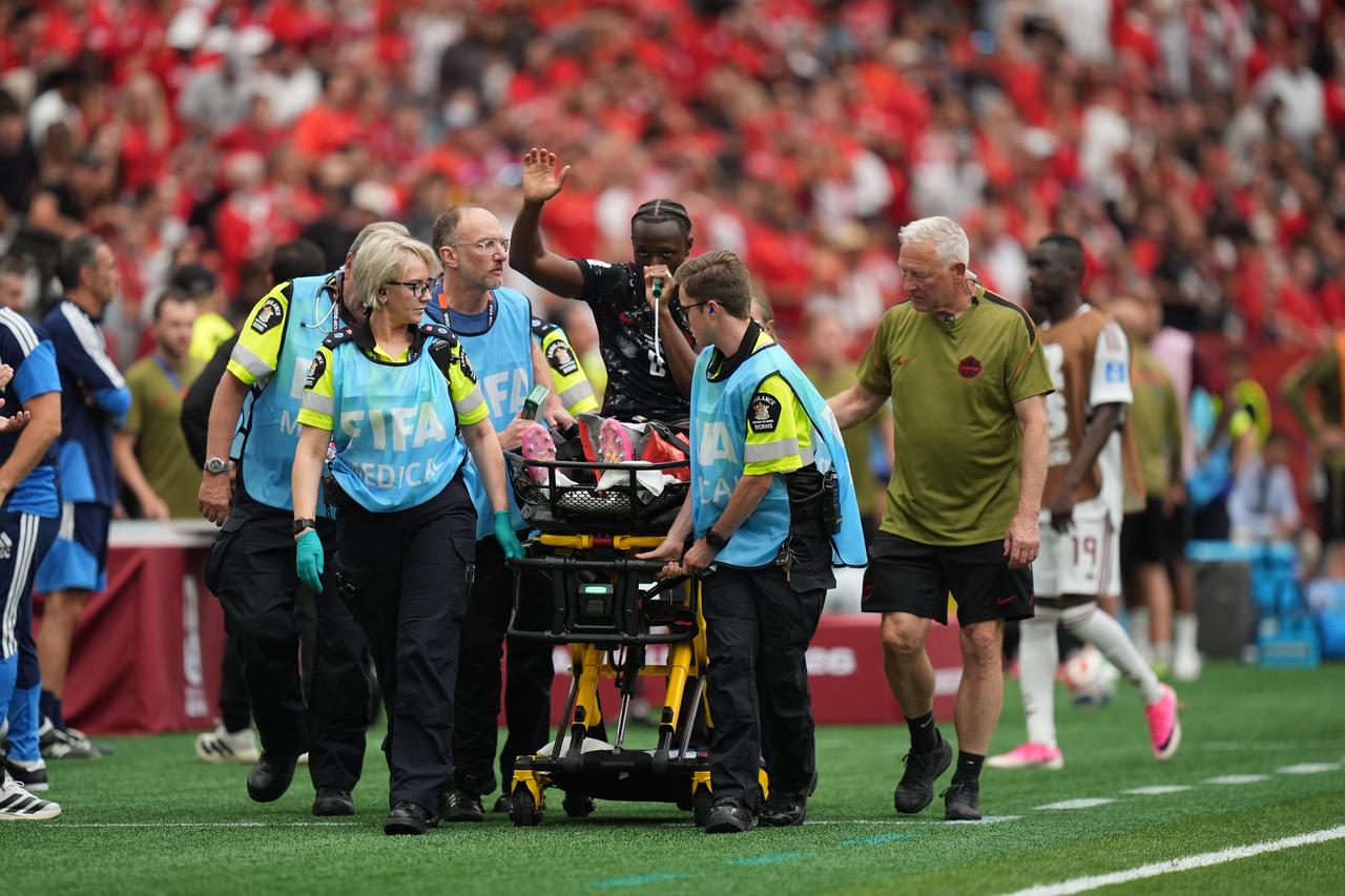 Injured Canada player Ismael Kone waving to the fans as he was stretchered off the pitch. (AA Photo)