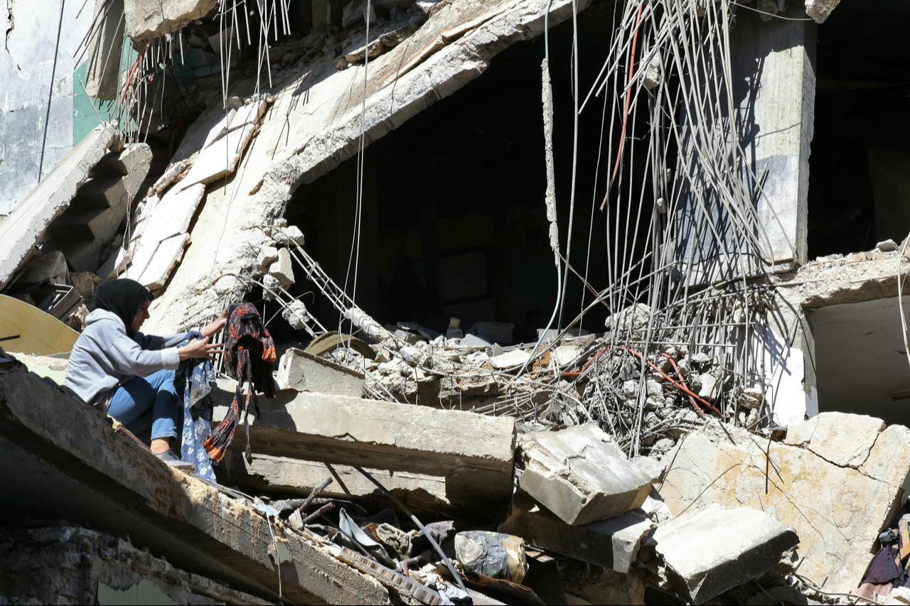 A woman searches for salvageable items in the rubble of her home after returning to the southern Lebanese village of Kfar Roummane, June 18, 2026. (AFP Photo)