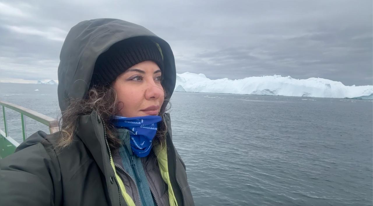 Ilulissat Icefjord: Researcher and journalist Dr. Esra Ozturk during a field visit to Ilulissat, one of Greenland's most iconic UNESCO World Heritage sites, examining the glaciers that have become a global symbol of Arctic change. (Photo: Esra Ozturk)
